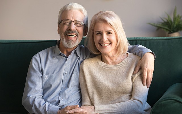 Couple smiling after cost of dentures in Chaska 