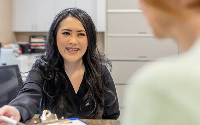 Dentist talking to mother and baby