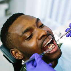 man havign his teeth examined