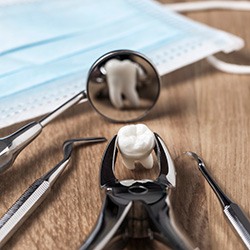 Dental pliers and instruments with an extracted tooth