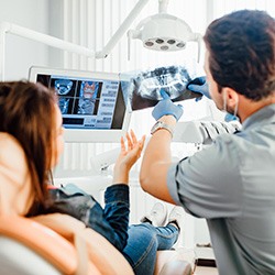 Dentist showing patient dental X-ray