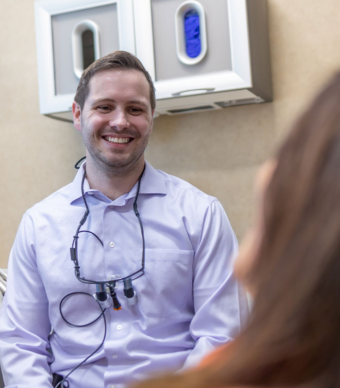 Chaska Minnesota dentist talking to woman in dental chair