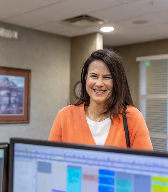 Smiling woman checking in at dental office in Chaska