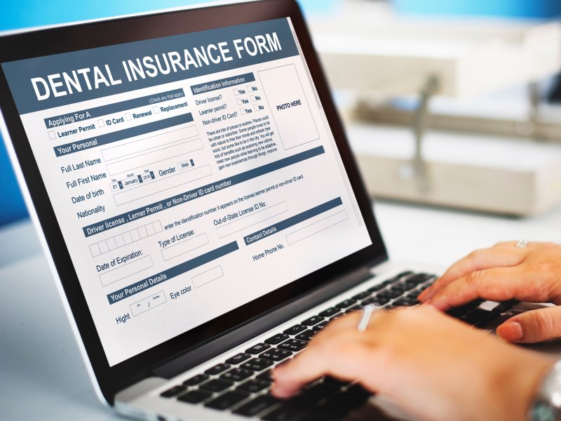 person filling out dental insurance information