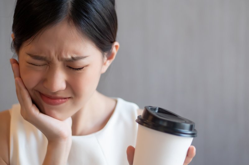 woman experiencing tooth sensitivity