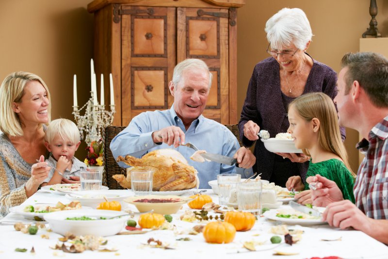 family seated at the table at Thanksgiving